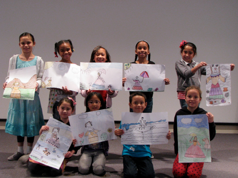 Kids showing their drawings for the photo